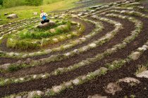 Woman meditating in stone labyrinth — Stock Photo