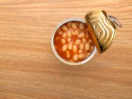 Top view of Open tin of baked beans on table — Stock Photo