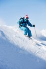 Male skiing downhill at speed — Stock Photo