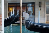 Rowboats docked in urban canal — Stock Photo