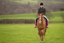 Adolescente menina equitação cavalo no campo — Fotografia de Stock