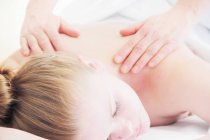 Woman having back massage in spa — Stock Photo