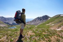 A backpacker stops to enjoy the view from a high elevation ridge in the Never Summer Wilderness, Colorado. — Stock Photo