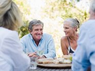Friends at meal outdoors — Stock Photo