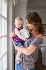 Mother and baby playing with tambourine — Stock Photo