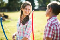 Teenage girl talking to brother whilst practicing archery — Stock Photo
