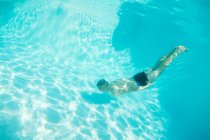 Man in goggles swimming in pool — Stock Photo