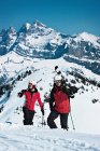 Skiers climbing snowy mountainside — Stock Photo