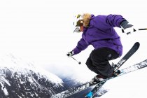 Low angle view of skier jumping on snowy slope — Stock Photo