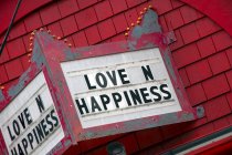 Love is happiness sign on building exterior — Stock Photo