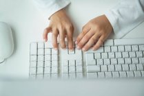 Child typing on computer keyboard, close-up partial view — Stock Photo