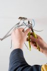 Electrician worker hands cutting wires — Stock Photo