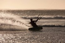 Man windsurfing in waves of teh sea — Stock Photo
