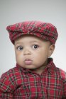 Cute baby wearing a flat cap — Stock Photo