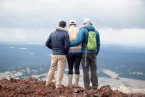 Três amigos em pé no cume do vulcão South Sister, olhando para a vista, Bend, Oregon, EUA — Fotografia de Stock