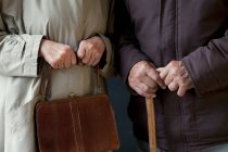 Uomo anziano con bastone da passeggio, donna anziana con borsa — Foto stock