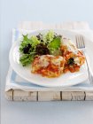 Baked cannelloni with salad on plate — Stock Photo