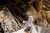 Girl looking at map in  canyon — Stock Photo