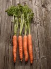 Carrots on wooden table — Stock Photo