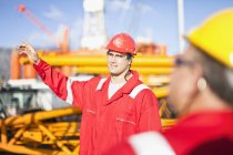 Workers talking on oil rig — Stock Photo