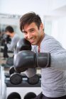 Boxer wearing boxing gloves in gym — Stock Photo