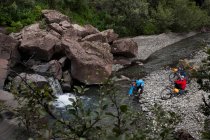 Couple crossing creek with bicycles, selective focus — Stock Photo