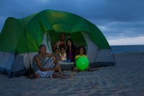 Family with four children in tent on Huntington Beach, California, USA — Stock Photo