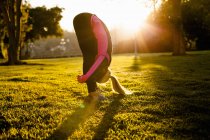 Woman stretching in park — Stock Photo
