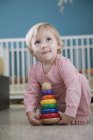 Female toddler playing with stacking toy — Stock Photo