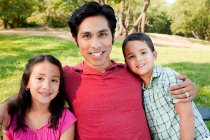 Man with son and daughter in park, portrait — Stock Photo