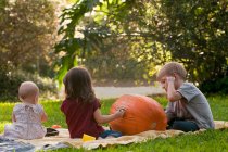 Children drawing on pumpkin — Stock Photo