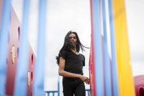 Young man with long hair in playground — Stock Photo