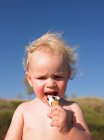 Toddler girl eating ice cream cone — Stock Photo