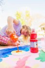Girl painting with tempera on paper — Stock Photo