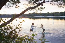 Jovem casal jogando no lago — Fotografia de Stock