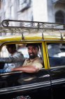 Smiling man riding in taxi cab, selective focus — Stock Photo