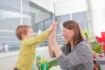 Mother playing with son at home — Stock Photo