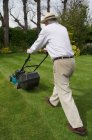 Man mowing garden lawn — Stock Photo
