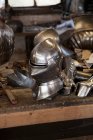 Metal helmet in blacksmith shop — Stock Photo