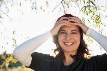 Smiling woman holding her forehead — Stock Photo