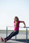 Runner stretching on rooftop — Stock Photo