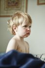 Toddler boy pouting in bed — Stock Photo