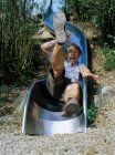 Excited man falling down slide. — Stock Photo