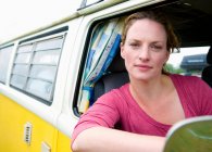 Woman at the wheel of a camper van — Stock Photo