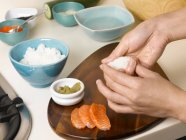 Woman preparing sushi at table — Stock Photo