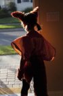 Rear view of Girl leaving house for trick or treating — Stock Photo