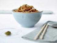 Bowl of noodles with chopsticks — Stock Photo