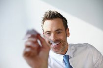 Businessman playing with paper airplane — Stock Photo