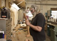 Guitar maker in workshop manufacturing guitar — Stock Photo