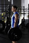 Man with barbell in a gym — Stock Photo